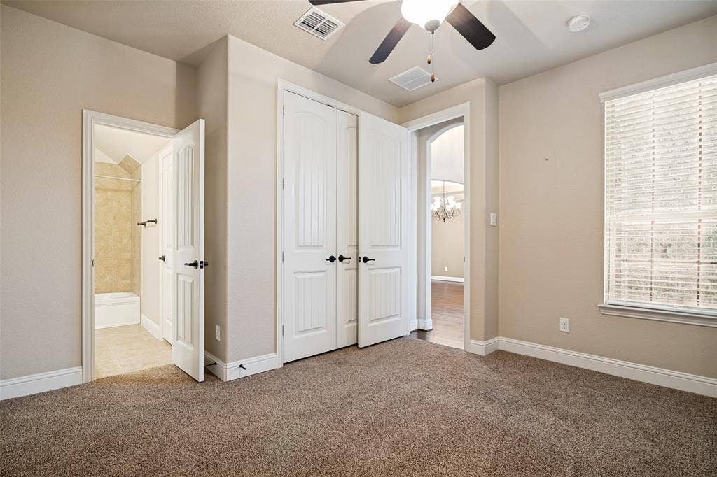 10002 Edgeway Circle, Rowlett, TX 75089 First-floor secondary bedroom off main entrance hall. Custom closet system.