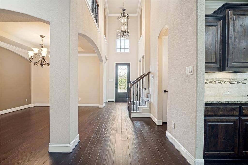 10002 Edgeway Circle, Rowlett, TX 75089 Entry hall facing metal and glass front door.