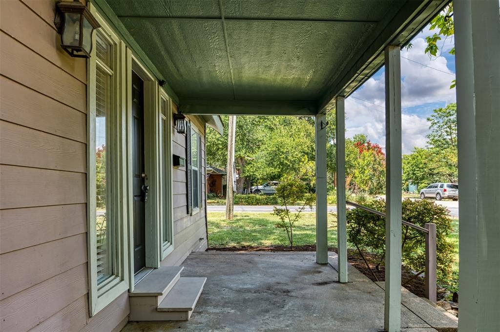 8823 San Benito Way, Dallas, TX 75218 Covered front porch with concrete flooring and wood support pillars