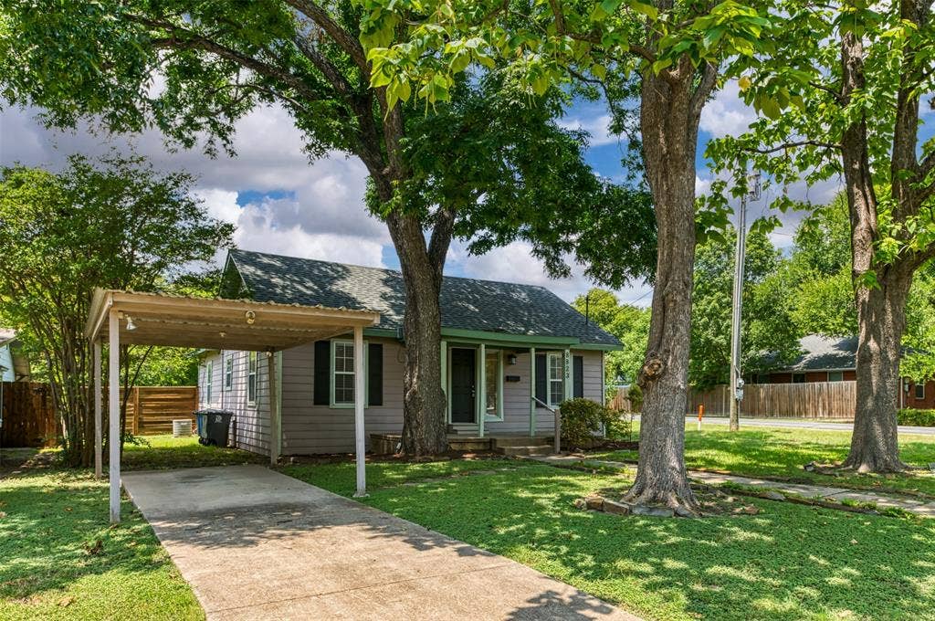 8823 San Benito Way, Dallas, TX 75218 Single-story residence featuring a covered carport, a concrete driveway, and mature trees