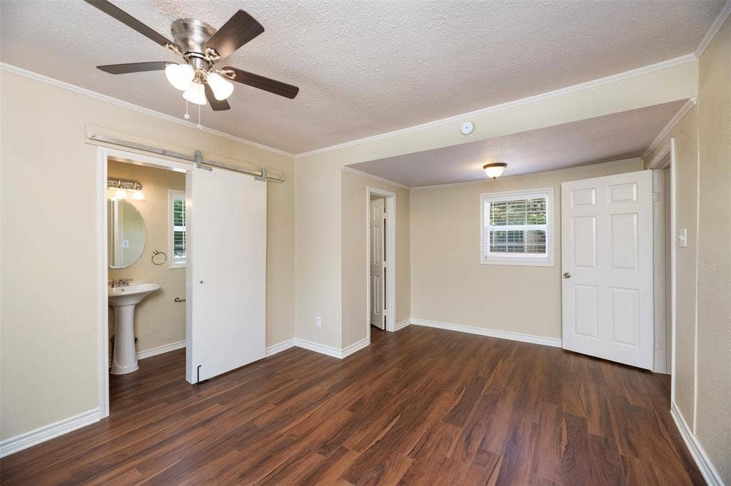 8823 San Benito Way, Dallas, TX 75218 Wood-finish flooring with a ceiling fan