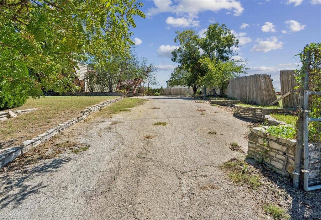 157 Business Boulevard, Granbury, TX 76049 View of street featuring driveway