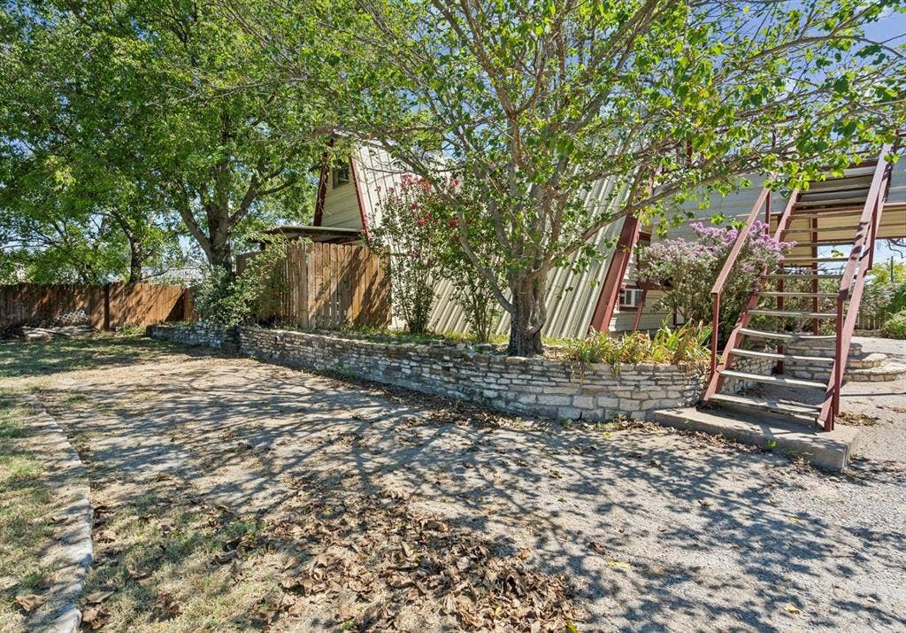 157 Business Boulevard, Granbury, TX 76049 View of yard featuring stairway and fence