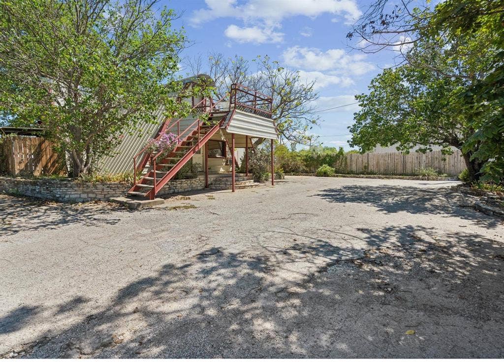 157 Business Boulevard, Granbury, TX 76049 View of yard featuring fence, stairs, and a deck