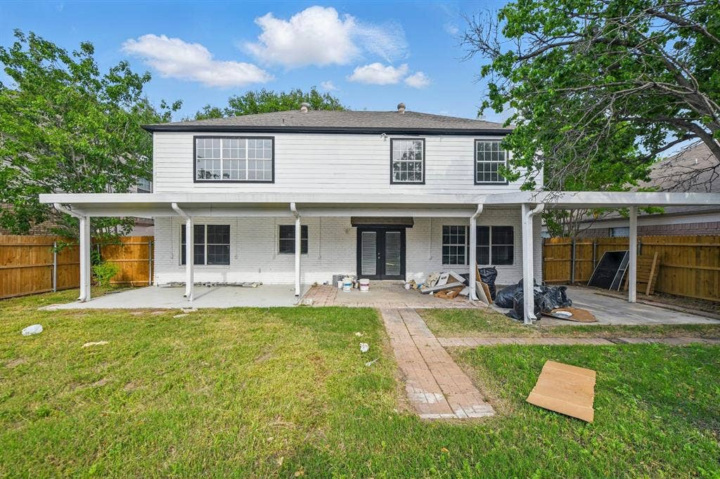 6833 Lyndale Drive, Watauga, TX 76148 Back of property with a patio area, a fenced backyard, brick siding, and french doors