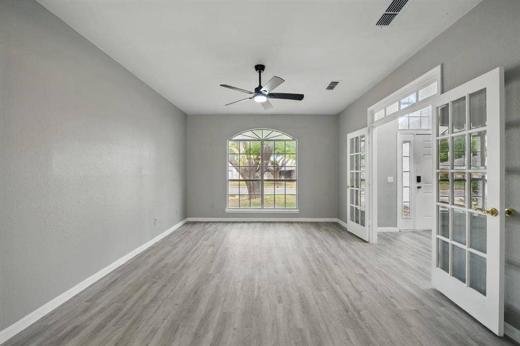6833 Lyndale Drive, Watauga, TX 76148 Spare room with french doors, wood finished floors, and ceiling fan