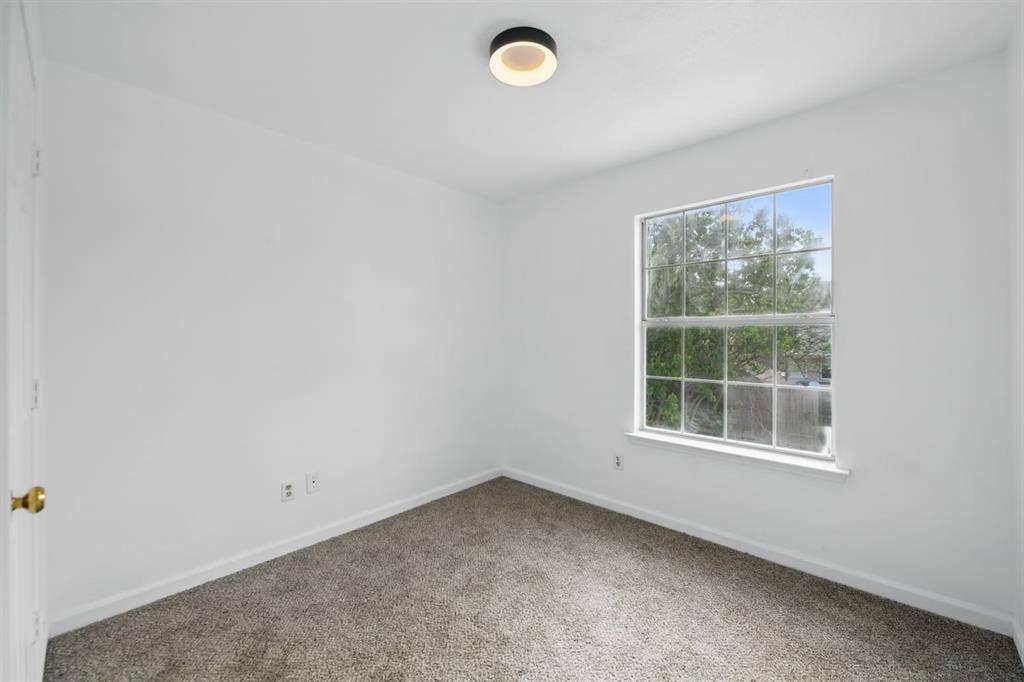 6833 Lyndale Drive, Watauga, TX 76148 Spare room featuring carpet and baseboards