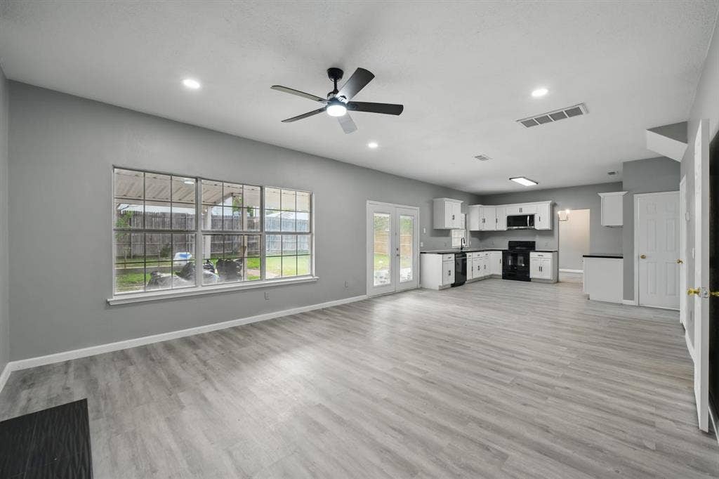 6833 Lyndale Drive, Watauga, TX 76148 Unfurnished living room with a ceiling fan, light wood finished floors, french doors, and recessed lighting