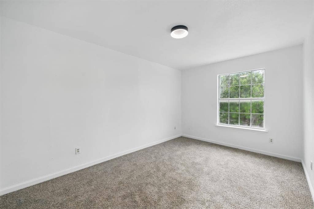 6833 Lyndale Drive, Watauga, TX 76148 Carpeted spare room featuring baseboards
