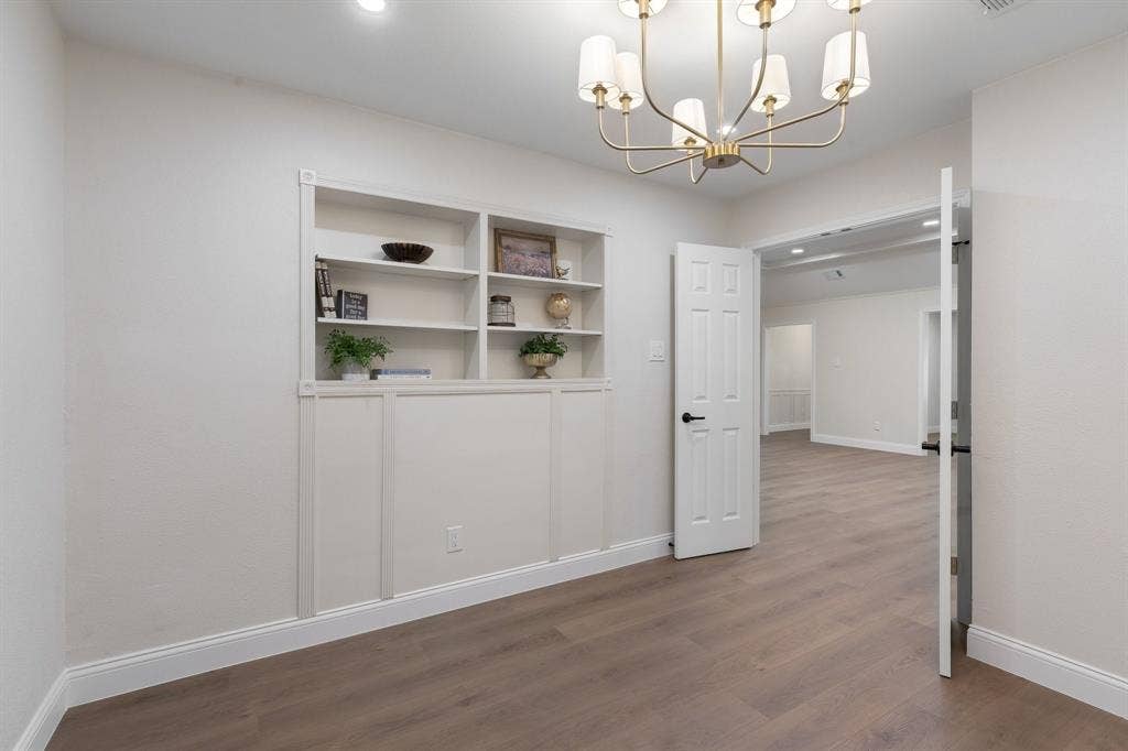 2844 Hurstview Drive, Hurst, TX 76054 Built-in shelving with recessed lighting, a modern chandelier