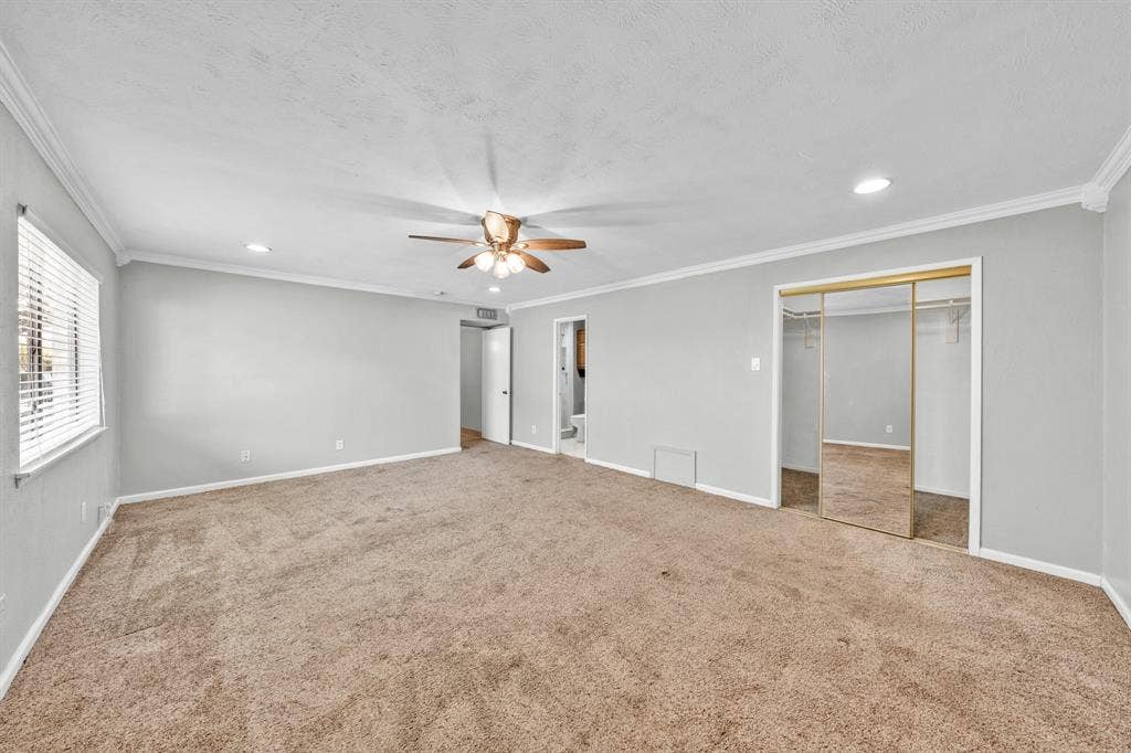 1715 Cherokee Trail, Plano, TX 75023 Expansive carpeted room featuring a ceiling fan, recessed lighting, crown molding, and sliding mirrored closet doors