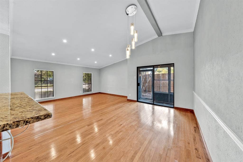 1715 Cherokee Trail, Plano, TX 75023 Wood-finish flooring throughout, recessed lighting, and a modern chandelier