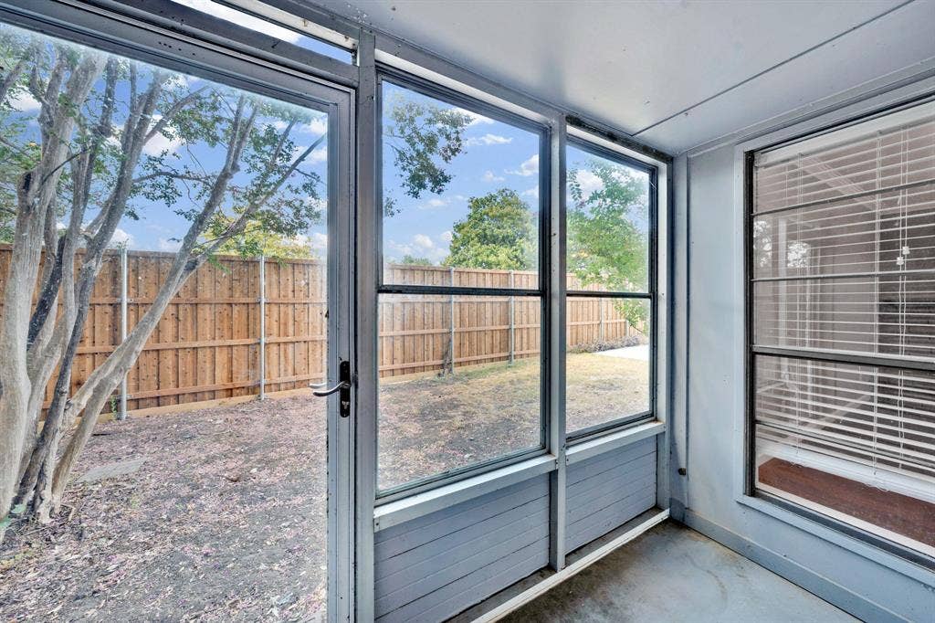 1715 Cherokee Trail, Plano, TX 75023 Enclosed patio featuring multiple window panels, a privacy fence, and concrete flooring