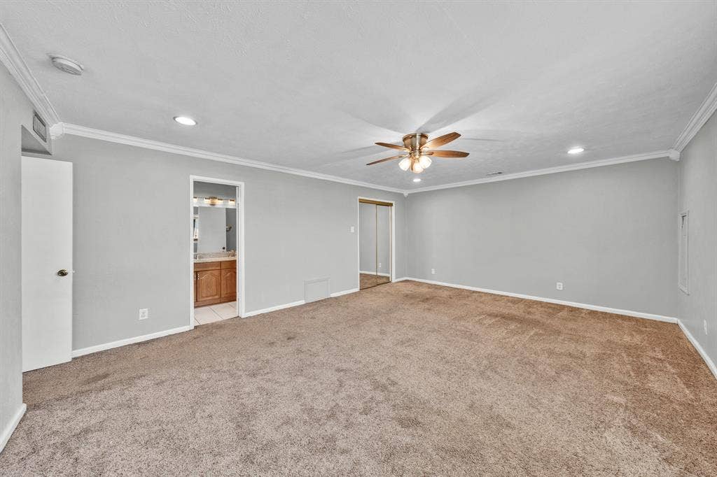 1715 Cherokee Trail, Plano, TX 75023 Spacious room featuring carpeting, crown molding, a ceiling fan, recessed lighting, and mirrored closet doors
