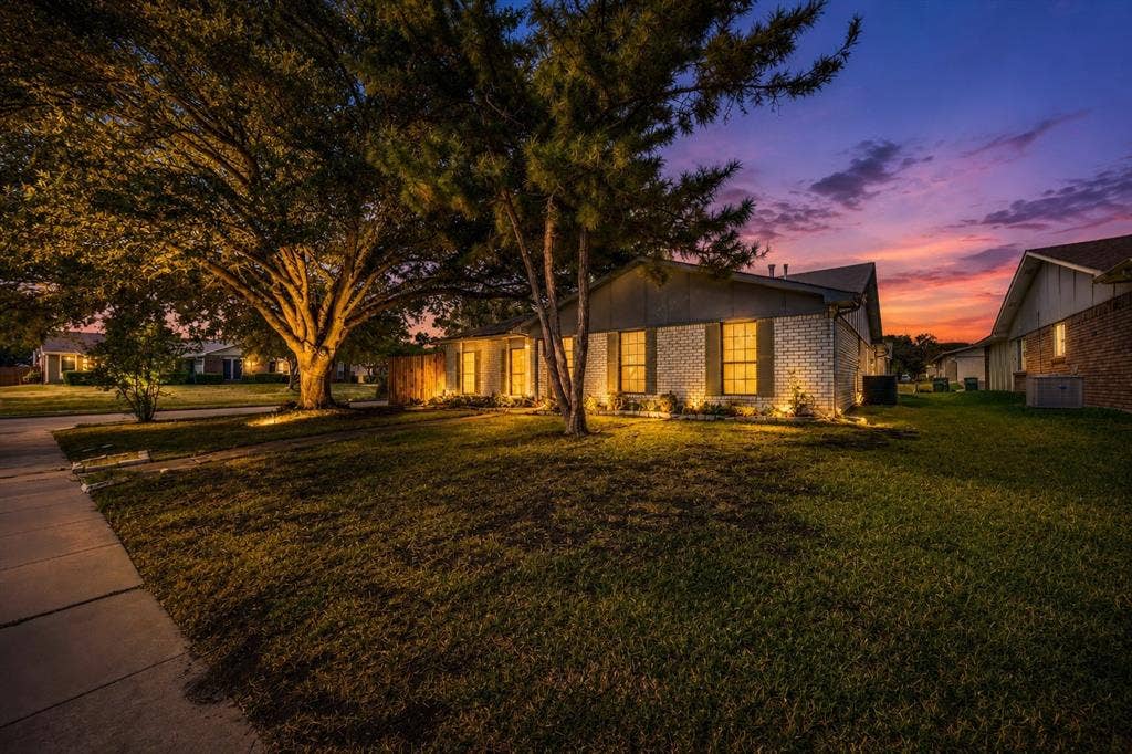 1715 Cherokee Trail, Plano, TX 75023 Brick exterior with dark shutters, mature trees, and a manicured lawn