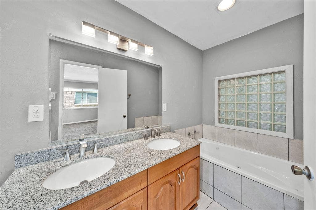 1715 Cherokee Trail, Plano, TX 75023 Dual vanity with light-toned countertop and undermount sinks
