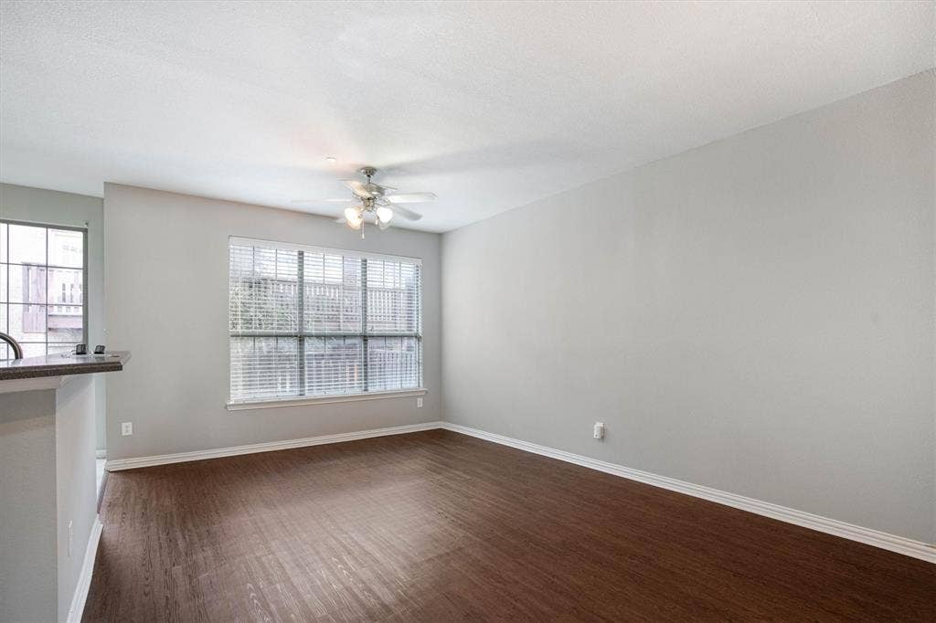 1441 Fox Run Drive, Irving, TX 75063 Dining, living area open to the kitchen with a back door balcony patio and fireplace