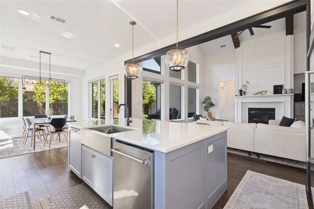 15018 Crape Myrtle Road, Frisco, TX 75035 Kitchen island with farmhouse sink and integrated dishwasher, wood-finish flooring, and high ceilings with exposed beams