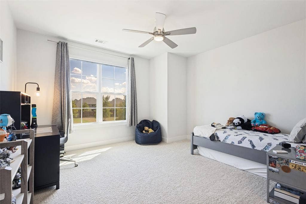 15018 Crape Myrtle Road, Frisco, TX 75035 Expansive window, modern ceiling fan with lighting, light-colored carpeting, and light-toned walls