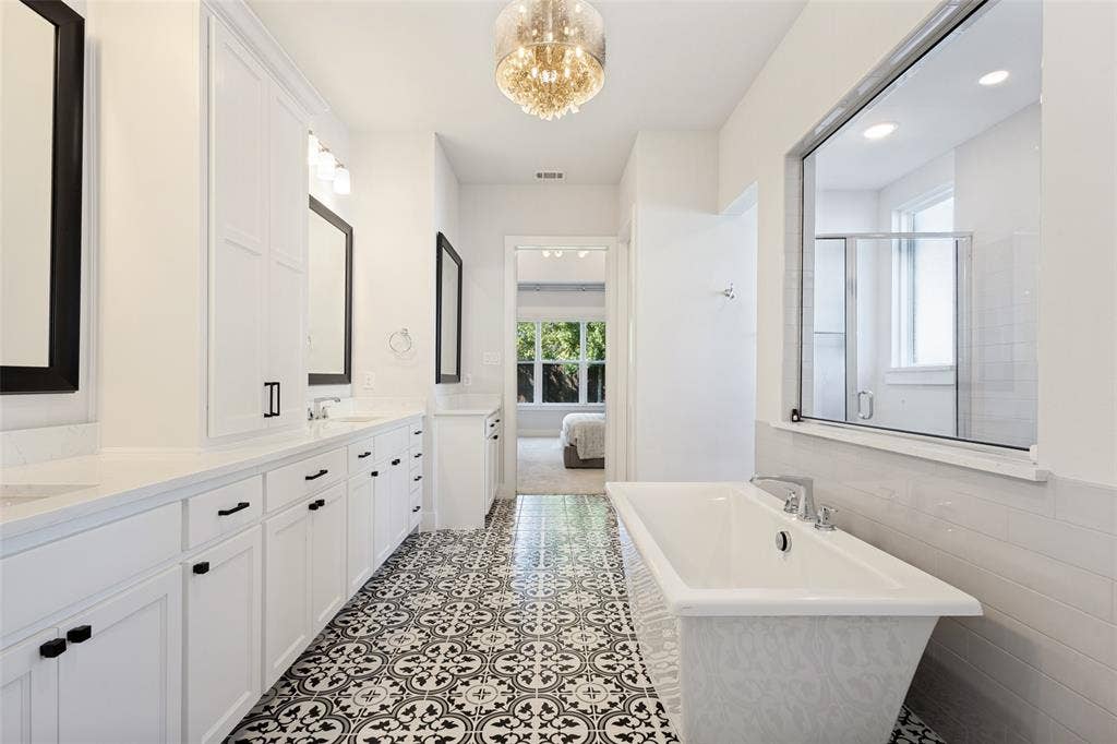 15018 Crape Myrtle Road, Frisco, TX 75035 Dual vanity with white cabinetry, pattern tile flooring, freestanding bathtub, and a built-in shower enclosure