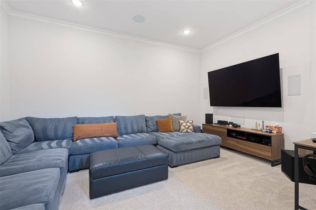 15018 Crape Myrtle Road, Frisco, TX 75035 Recessed lighting, crown molding, wall-mounted television, and a wood-finish media console