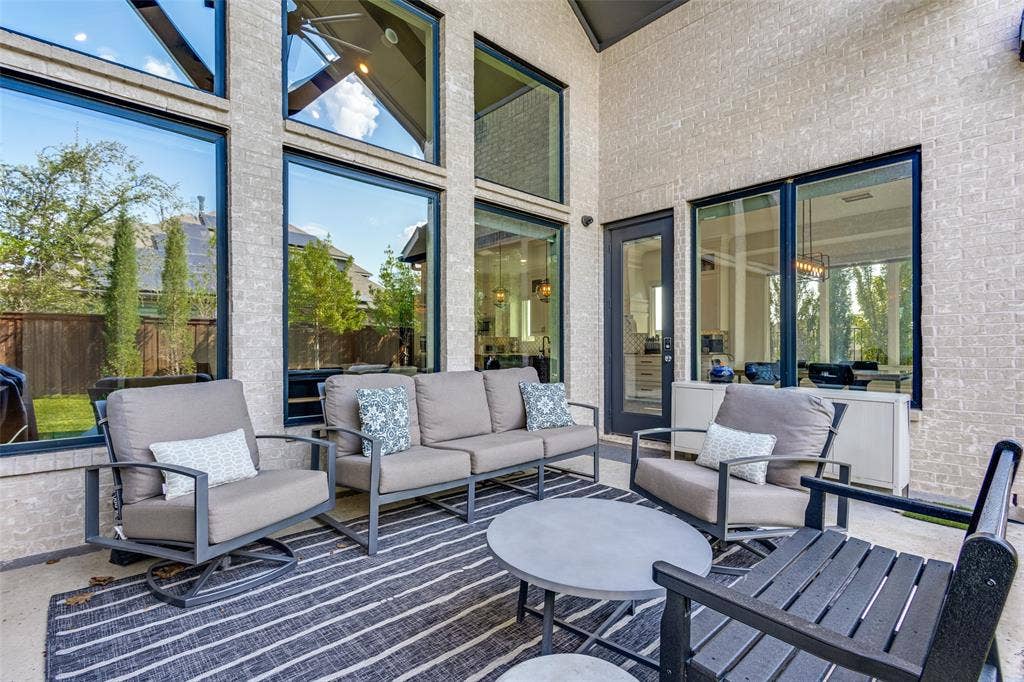15018 Crape Myrtle Road, Frisco, TX 75035 Covered patio with a high ceiling, brick exterior, and expansive windows