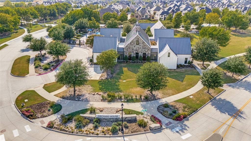 15018 Crape Myrtle Road, Frisco, TX 75035 Modern farmhouse-style architecture with stone and vertical siding, complemented by dark metal roofing