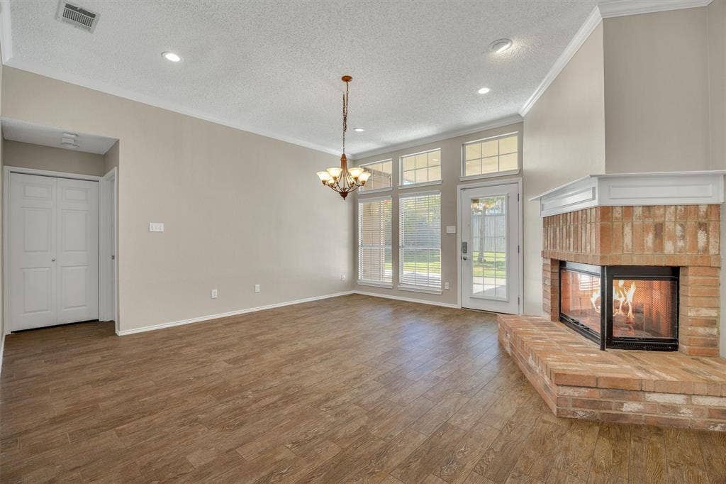 12 Harper Drive, Allen, TX 75002 Family room with kitchen behind you - fireplace can be seen from both!