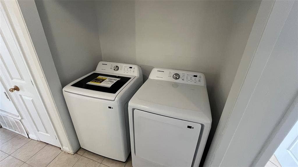 Full-size brand new Samsung laundry appliances within a dedicated alcove