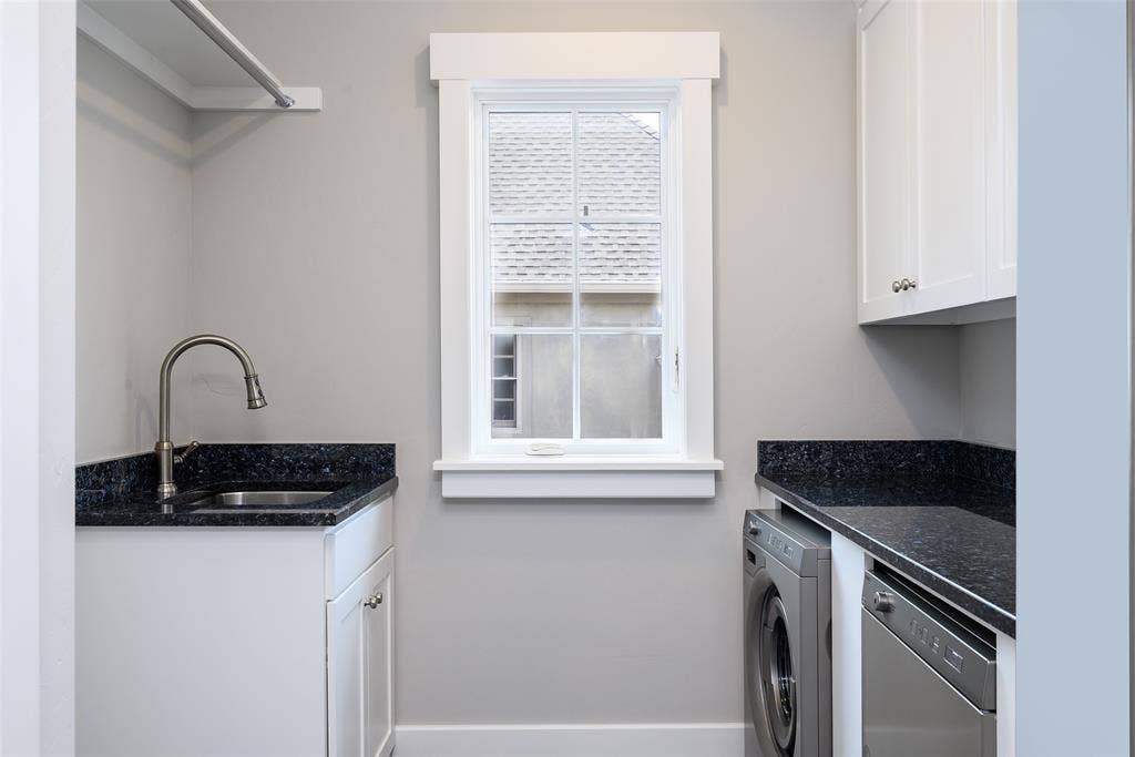 3420 Hanover Street, University Park, TX 75225 Utility room with white shaker cabinetry, dark speckled countertops, and a single-basin stainless steel sink with a gooseneck faucet