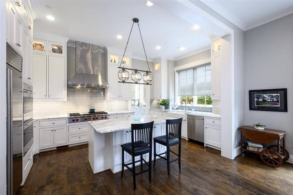 3420 Hanover Street, University Park, TX 75225 Kitchen featuring hardwood flooring, white cabinetry, granite countertops, a built-in range, and a stainless steel range hood