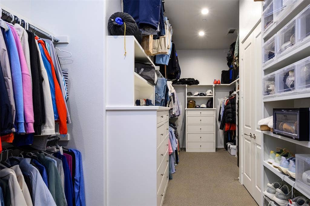 3420 Hanover Street, University Park, TX 75225 Walk-in closet featuring recessed lighting, built-in shelving, integrated drawers, and a neutral carpeted floor