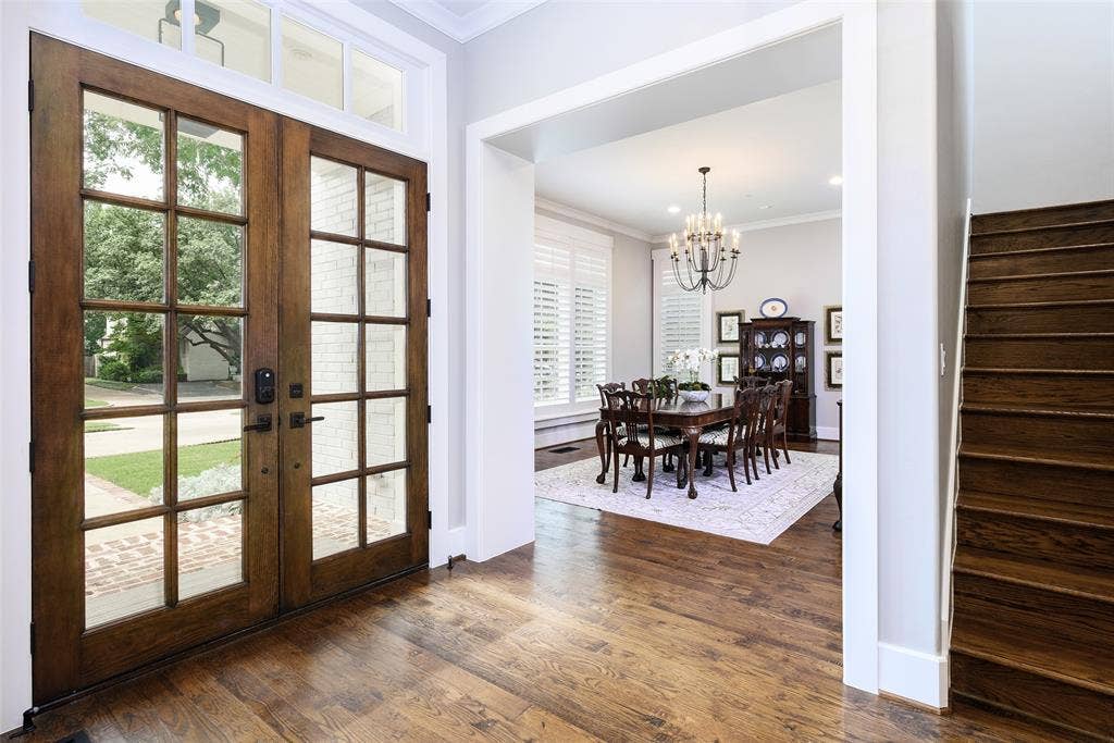 3420 Hanover Street, University Park, TX 75225 Wood-finish flooring throughout the entry, double front doors with transom, and a dedicated dining space featuring a chandelier and window shutters