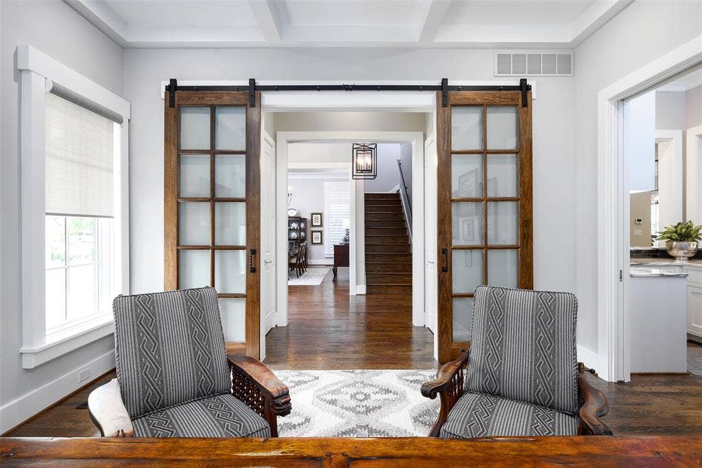 3420 Hanover Street, University Park, TX 75225 Solid wood flooring, coffered ceiling, transom window, and sliding barn doors with frosted glass panels