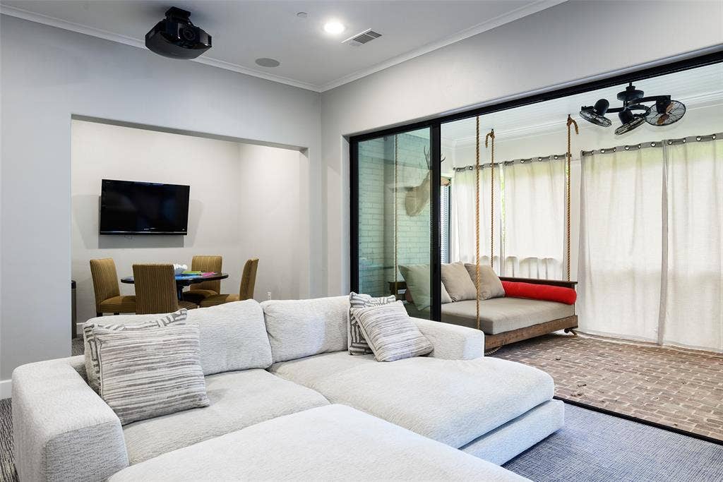 3420 Hanover Street, University Park, TX 75225 Built-in projector, recessed lighting, and large sliding glass doors