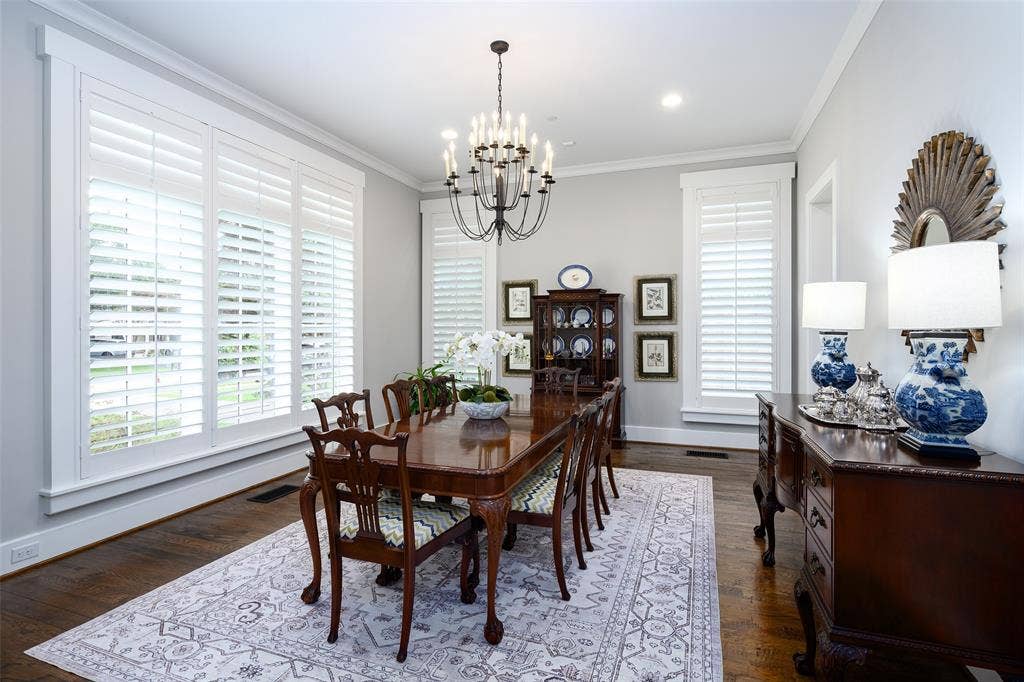 3420 Hanover Street, University Park, TX 75225 Hardwood flooring, crown molding, white plantation shutters, built-in cabinetry, and a chandelier