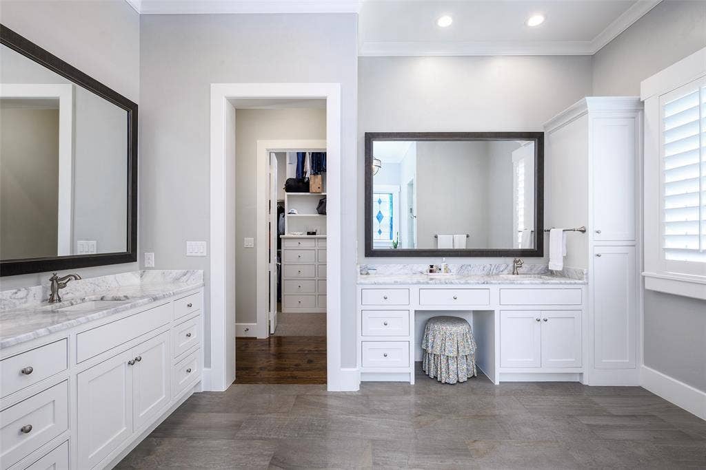 3420 Hanover Street, University Park, TX 75225 Dual vanity with white cabinetry, stone countertops, and undermount sinks