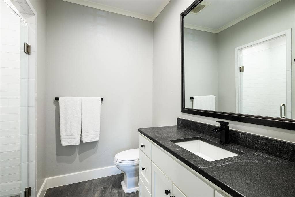 3420 Hanover Street, University Park, TX 75225 Glass-enclosed shower with white tiled walls