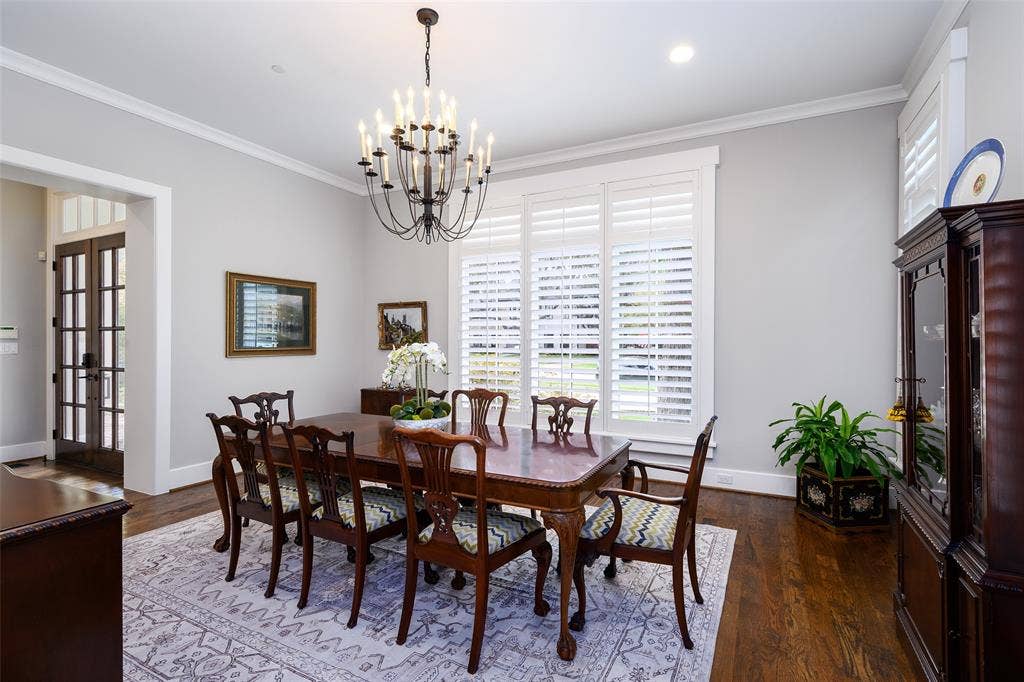 3420 Hanover Street, University Park, TX 75225 Recessed lighting, crown molding, wood-finish flooring, white window shutters, and a dark bronze chandelier