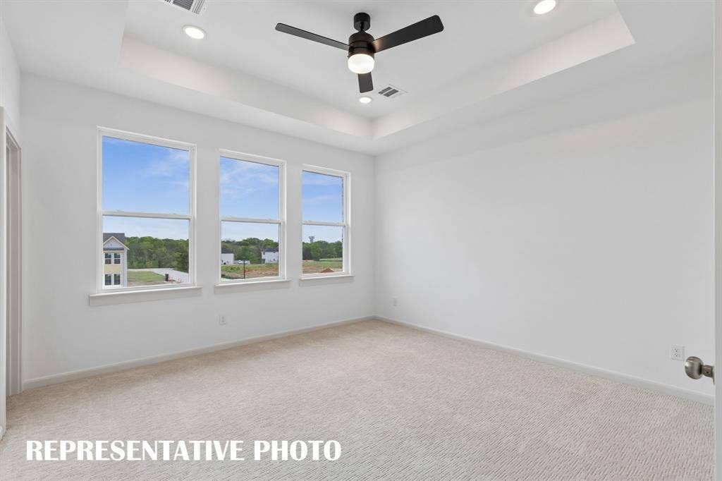 3601 Shepherd Way, McKinney, TX 75071 Featuring high ceilings, a wall of windows and plush carpeting, this dreamy new owner' suite is the perfect place to relax at the end of the day. REPRESENTATIVE PHOTO