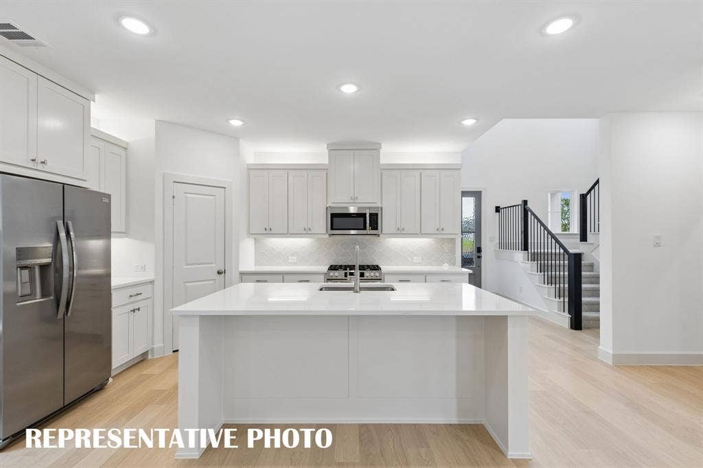 3601 Shepherd Way, McKinney, TX 75071 The spacious kitchen island is the hub of your new dream kitchen offering the perfect gathering space for friends and family. REPRESENTATIVE PHOTO