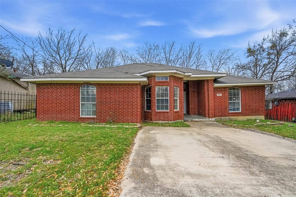 201 West Lane, West Tawakoni, TX 75474 Brick exterior with a gabled roof and a concrete driveway