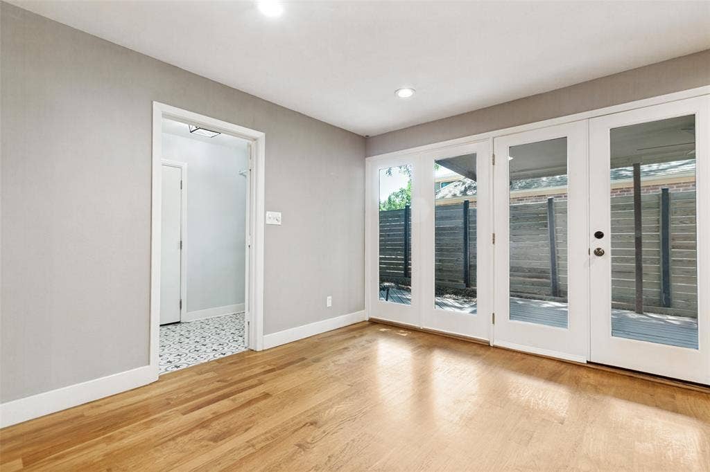 2937 Forest Hills Lane, Richardson, TX 75080 Wood-finish flooring with white baseboards, recessed ceiling lighting, and a neutral wall color