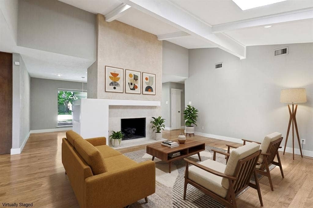 2937 Forest Hills Lane, Richardson, TX 75080 Vaulted ceiling with exposed beams, wood-finish flooring, fireplace with a hearth, and a skylight