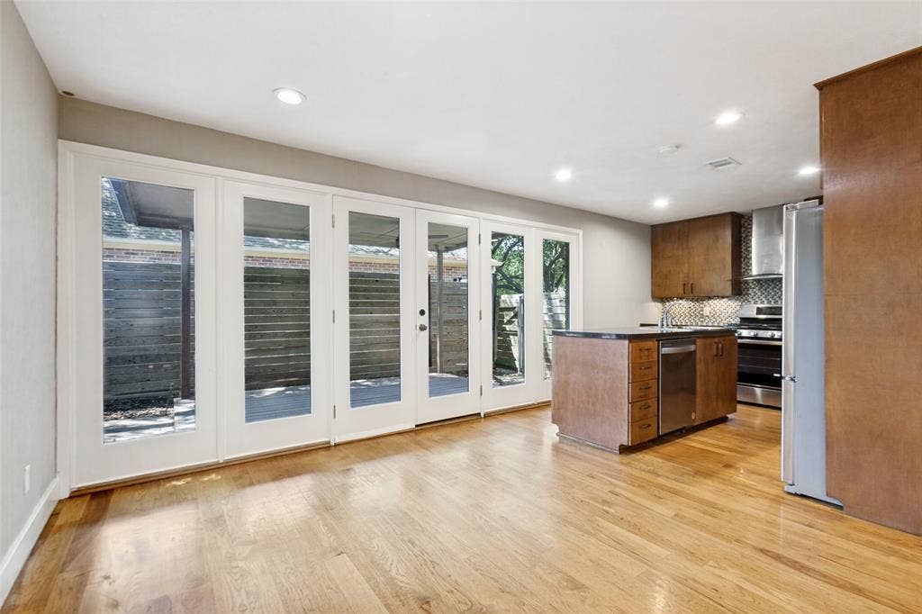 2937 Forest Hills Lane, Richardson, TX 75080 Hardwood flooring throughout, recessed lighting, and a kitchen island with integrated dishwasher