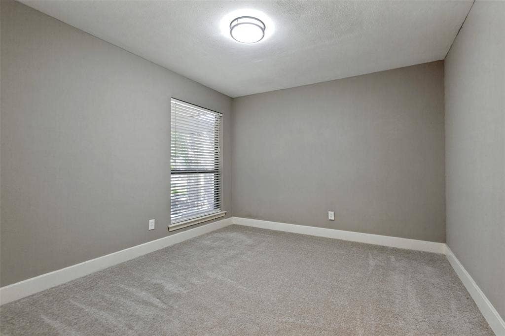 2937 Forest Hills Lane, Richardson, TX 75080 Recessed window with horizontal blinds, neutral wall paint, white trim, and light-colored carpeting