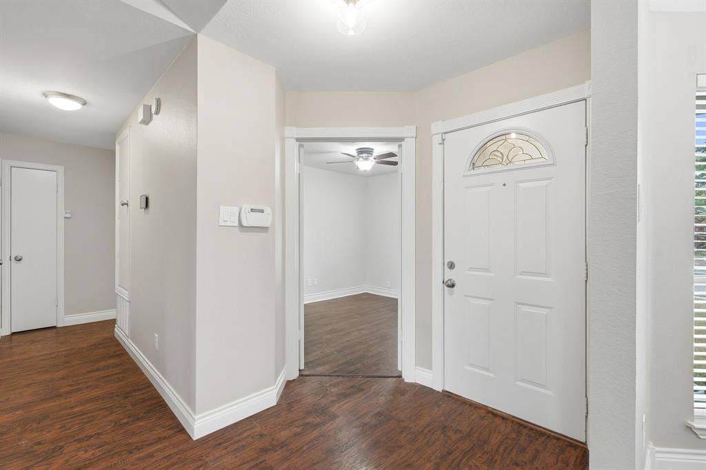 1309 Marigold Drive, Allen, TX 75002 Entry area with double doors to secondary bedroom with ceiling fan and closet.