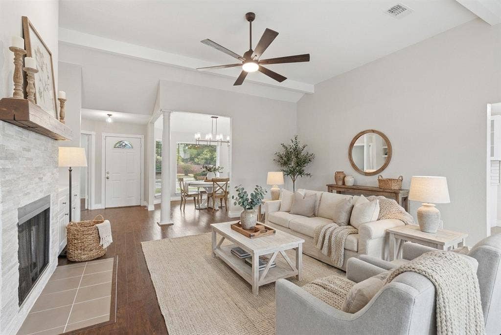 1309 Marigold Drive, Allen, TX 75002 Virtually staged. Living room with new ceiling fan, wood burning fireplace and built-in storage area with quartz countertops.
