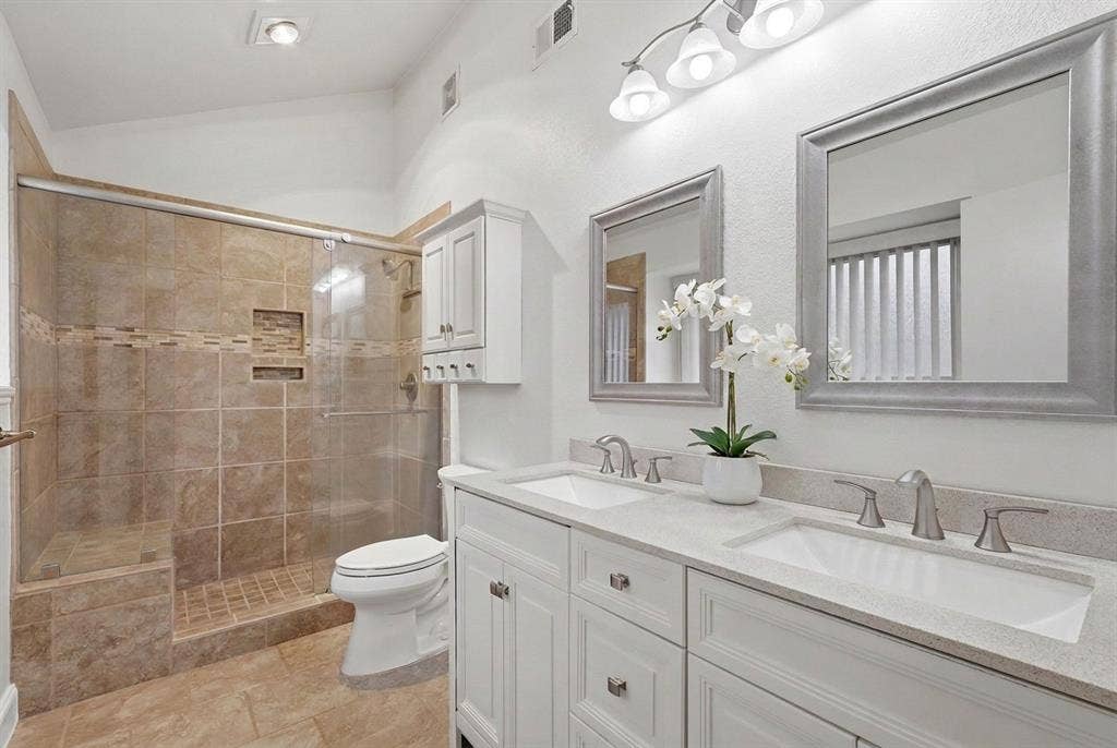 1309 Marigold Drive, Allen, TX 75002 Primary bathroom with dual sinks, new hardware and rimless glass shower door.