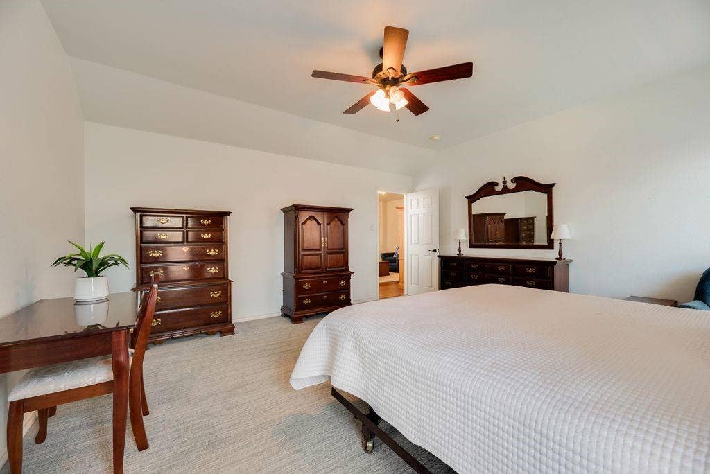 1485 Ashbourne Drive, Rockwall, TX 75087 Vaulted ceiling, ceiling fan, white walls, light-colored carpet, and an interior doorway
